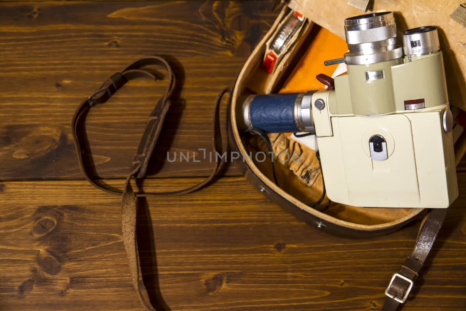 Vintage Super 8 cine camera from the 1960 with his original case on wooden background