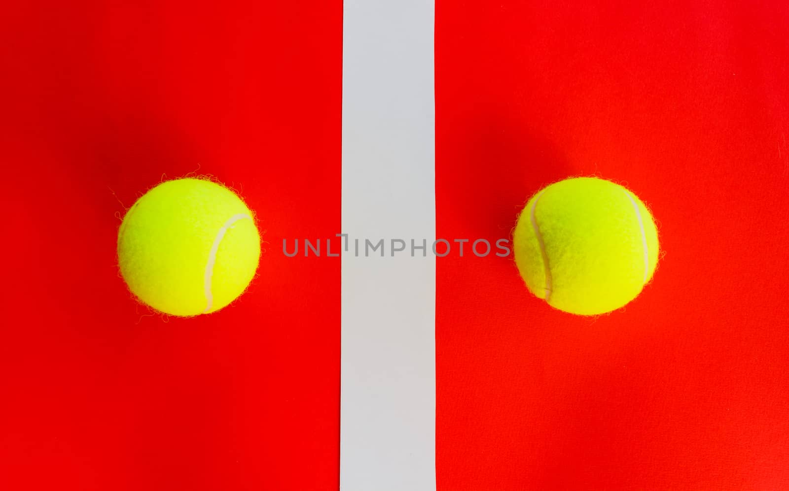 two tennis balls divided by a field line by grancanaria