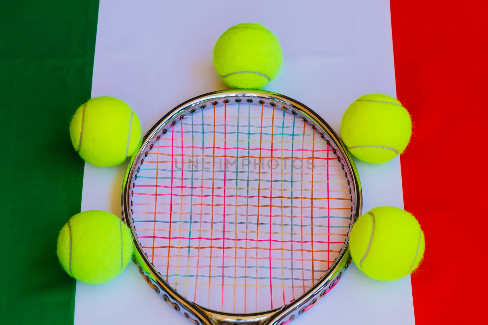 Tennis racket in metal with colored ropes and yellow tennis balls with the italian flag in the background