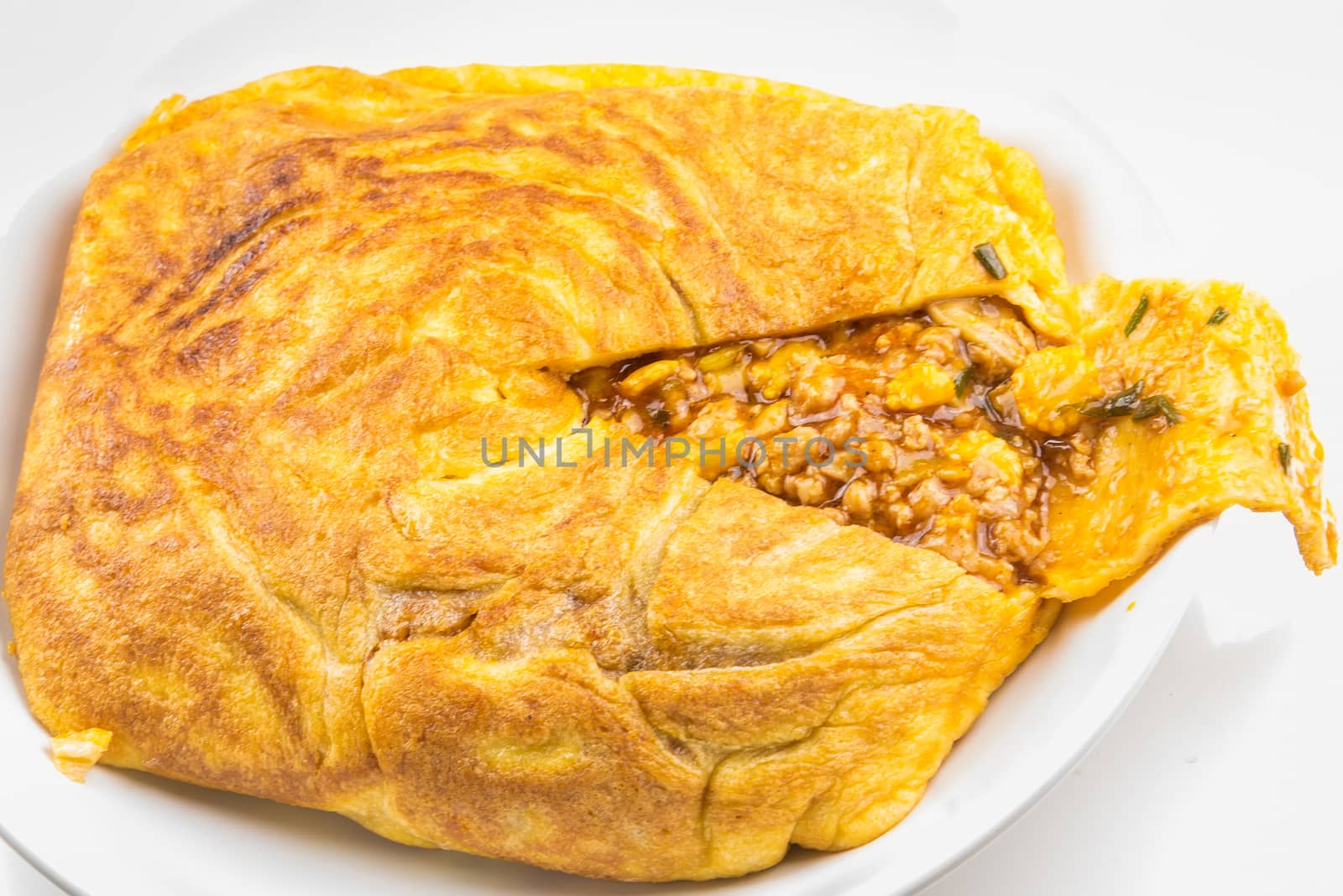 One Stuffed Thai Omelette on white plate on table.Stuffed eggs are Thai food.