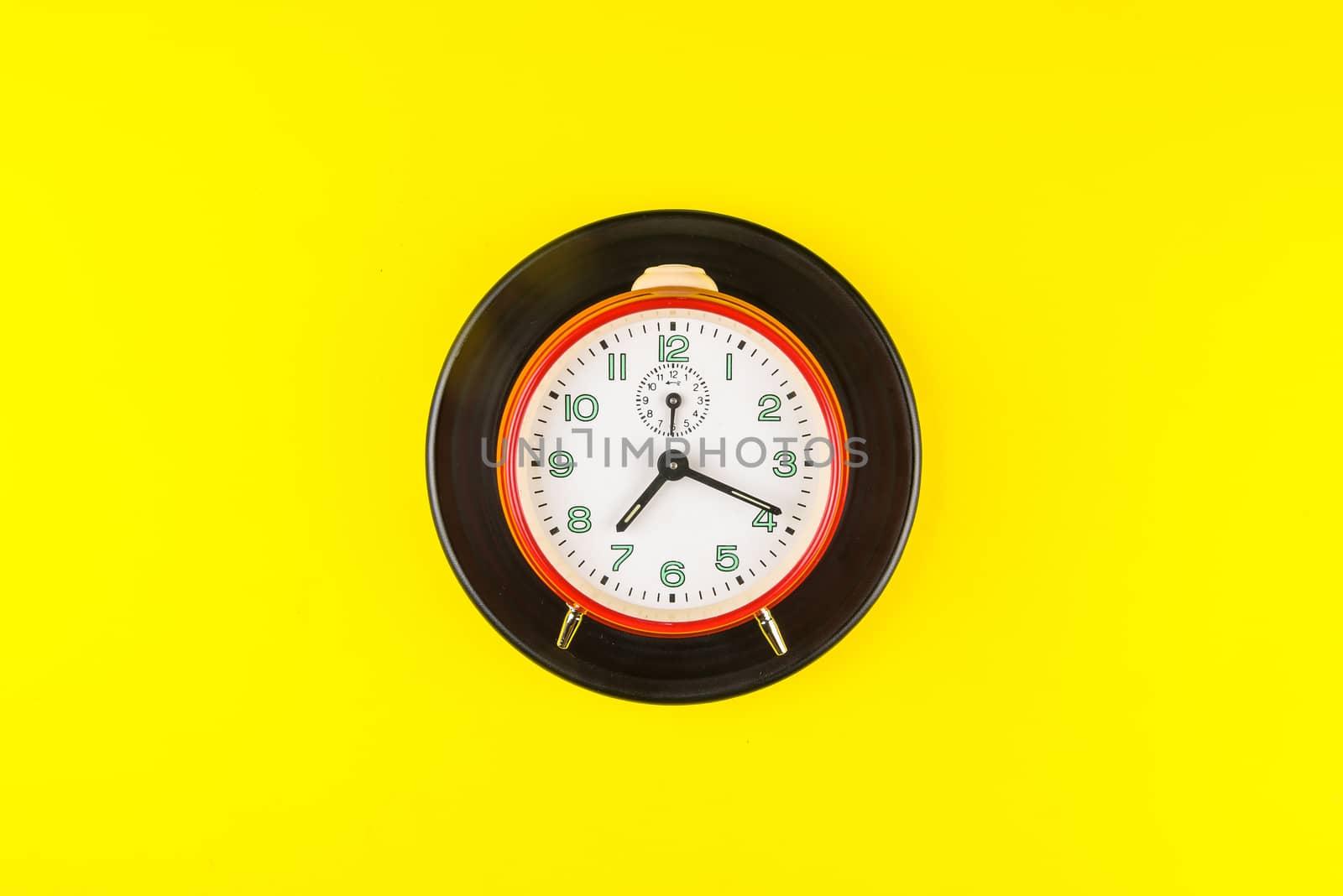 Red alarm clock isolated on yellow background, Time concept, Rus by Bubbers