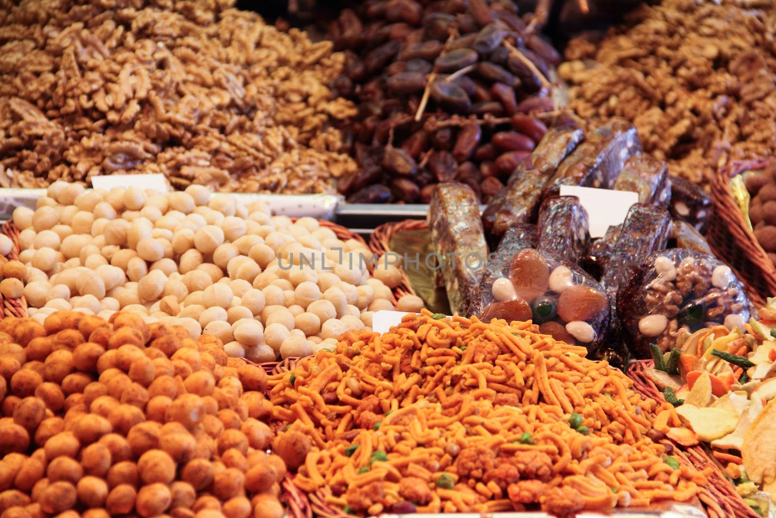 Nuts and various snacks on market close up