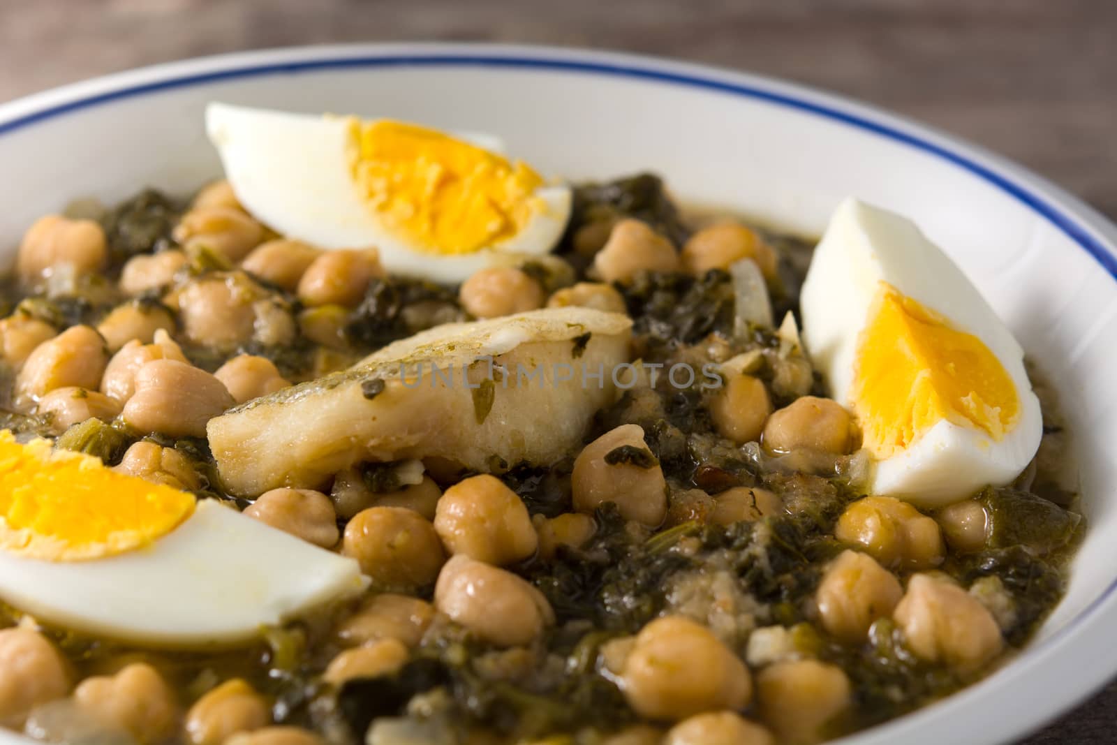 Chickpea stew with spinach and cod or potaje de vigilia. Typical spanish food for Easter holidays.