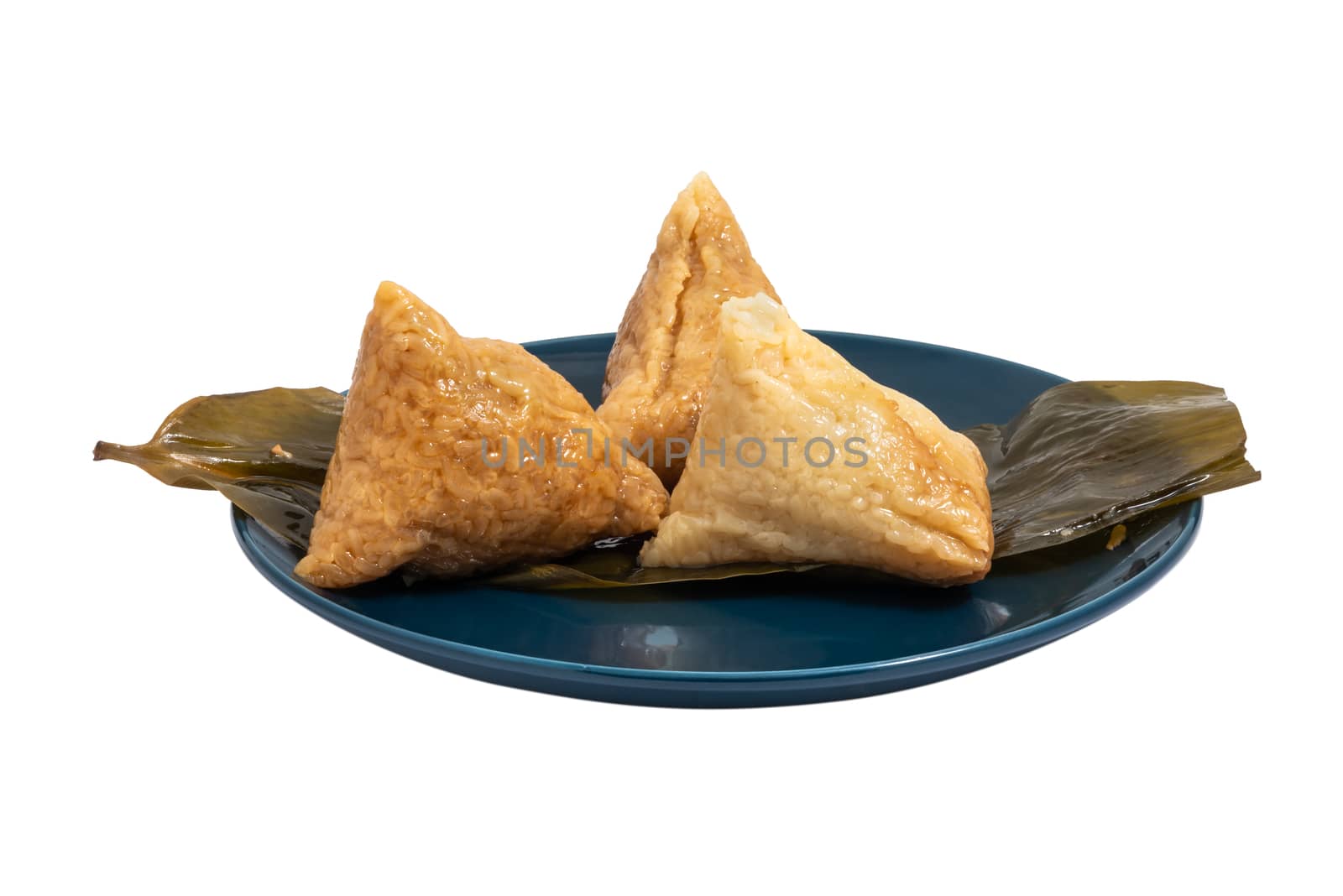 Three opened ZhongZi - traditional Chinese rice dish in bamboo leaves on a blue plate isolated on white
