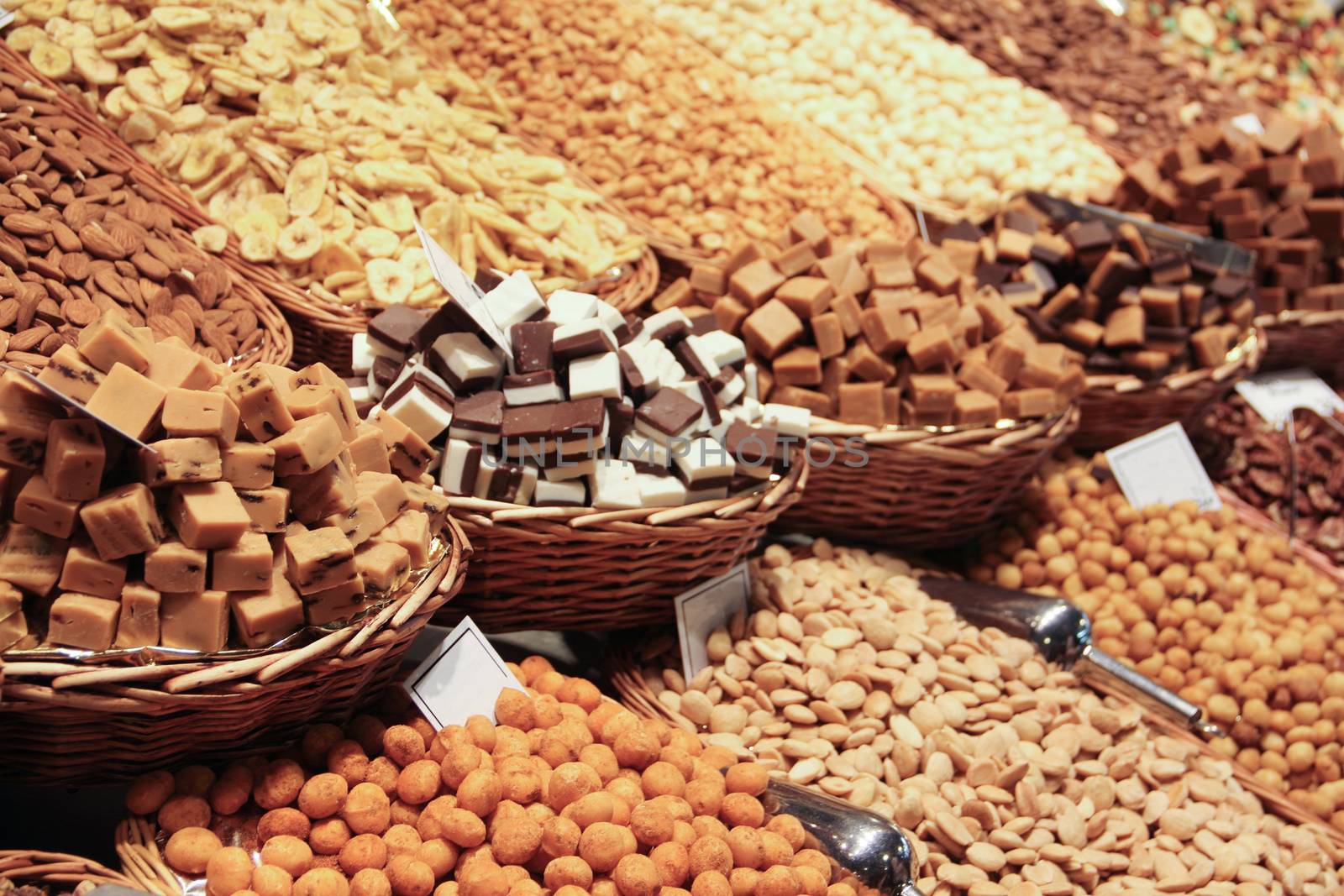 Dry fruits nuts sweets and snacks on the market stall close up