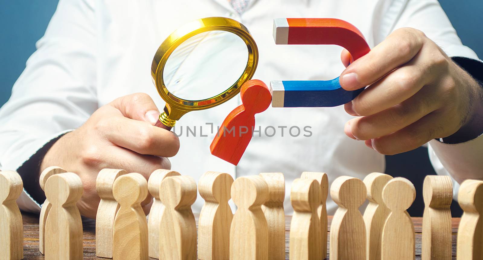 Businessman examines best candidate for work with a magnifying glass. Recruiting new workers, headhunters, staffing. Searching talented worker. Checking skills qualities. Hiring Human resources.