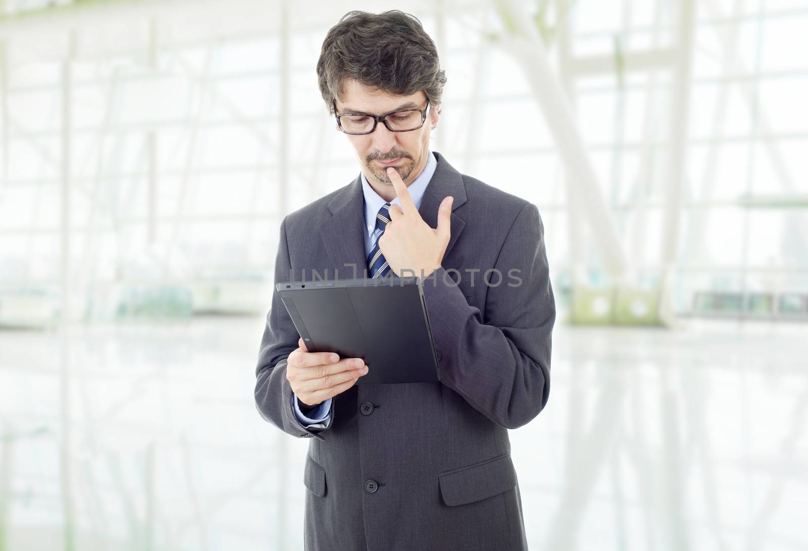 young businessman working with a tablet pc, at the office