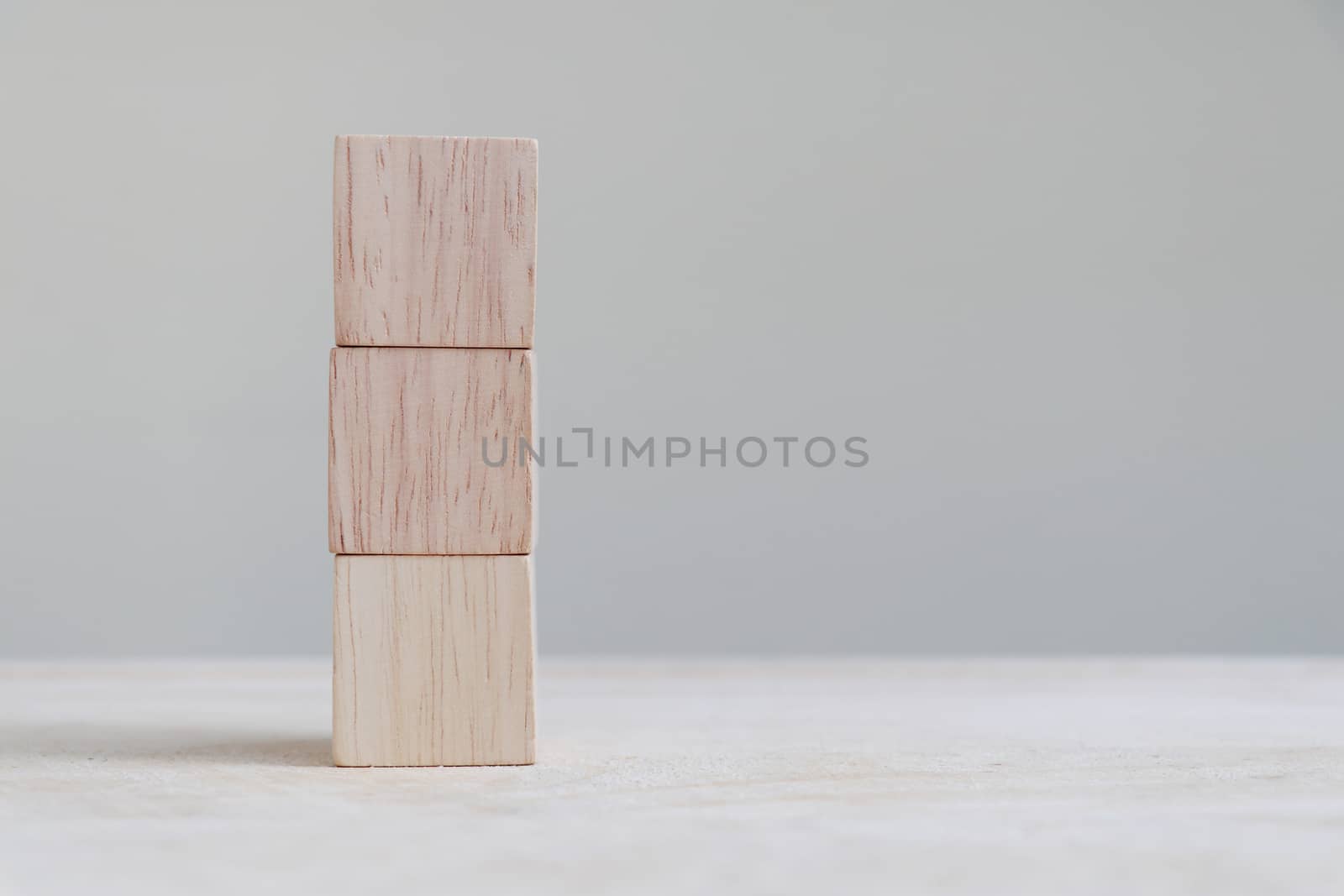 Three stacked wooden cubes with copy space on the right.