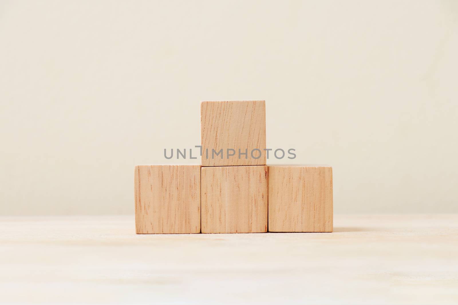 Wooden cube four pieces stacked on the floor.