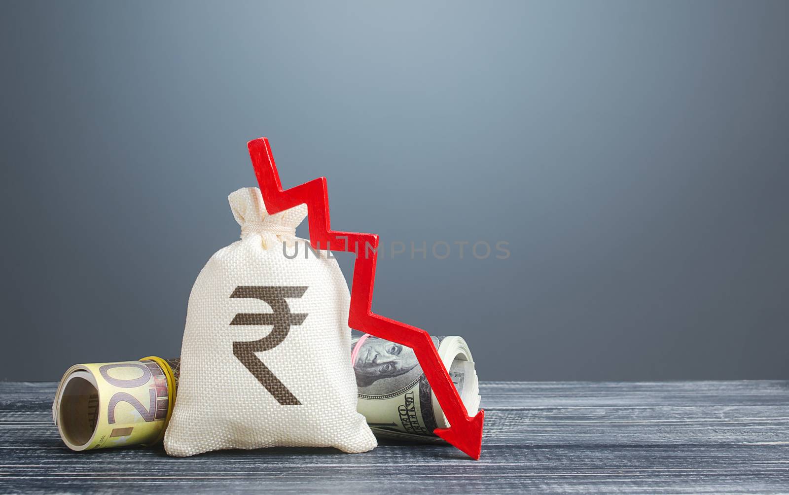 Indian rupee money bag and red arrow down. Economic difficulties. Capital flight, high risks. Costs expenses. Crisis, loss savings. Stagnation, recession, declining business activity, falling wealth. by iLixe48