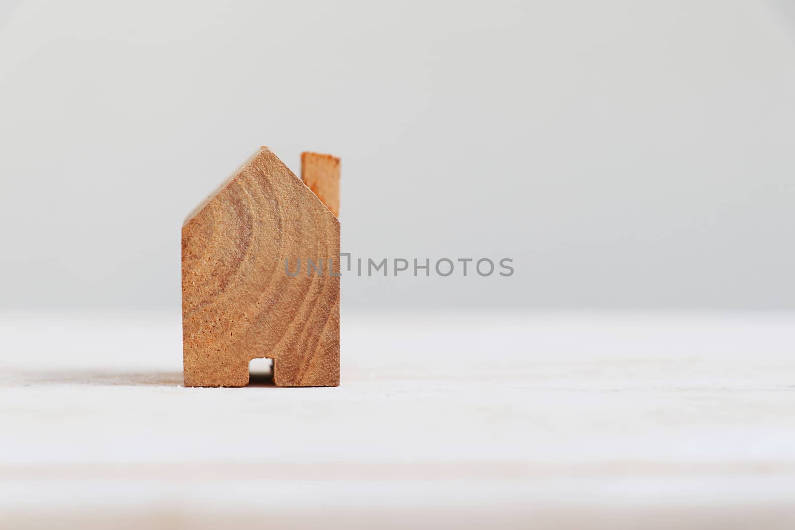 Wooden house model with copy space on the right.