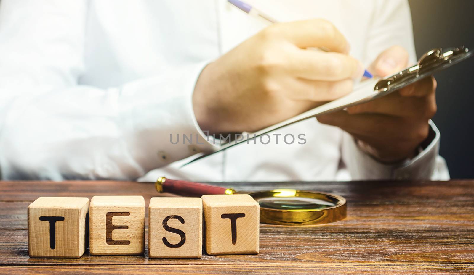 Man makes a test and writes results to a paper tablet. Quality control, organization process management. Medical testing for coronavirus COVID-19 infection. Review audit. Certification verification.