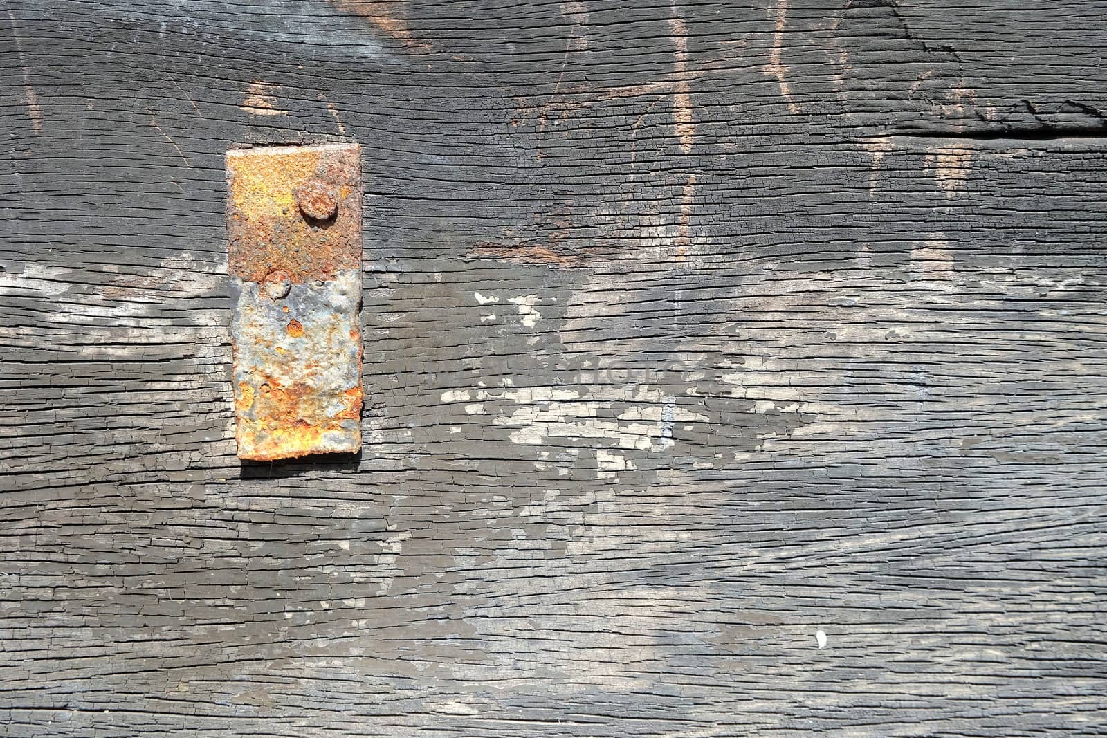 Rusty Piece of Metal on Old Wood Board.