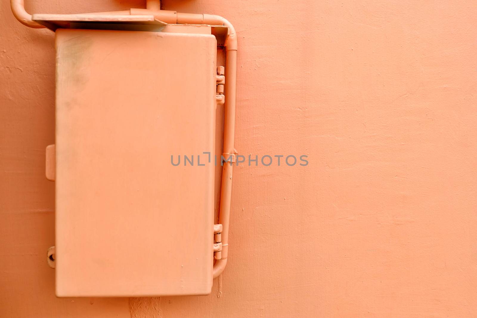 Electric Box with Flesh Tone Concrete Wall Background.