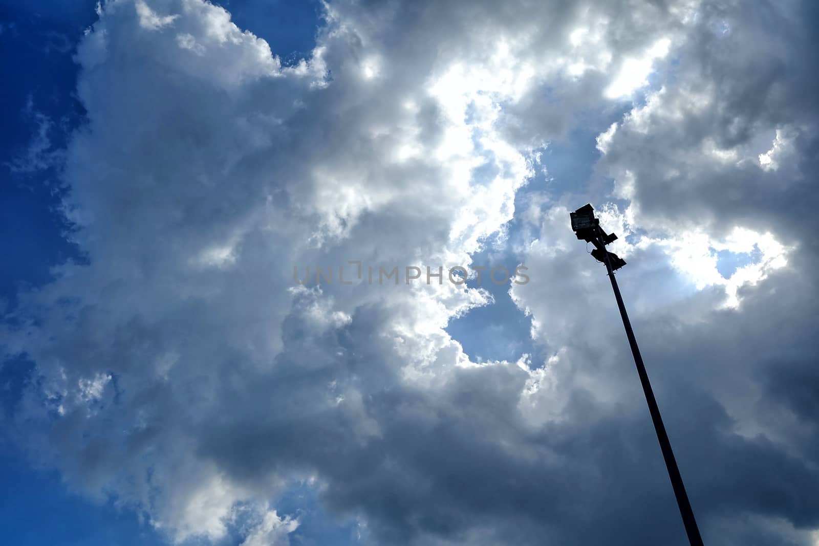 Spotlight Pole with Blue Sky and Clouds Background.