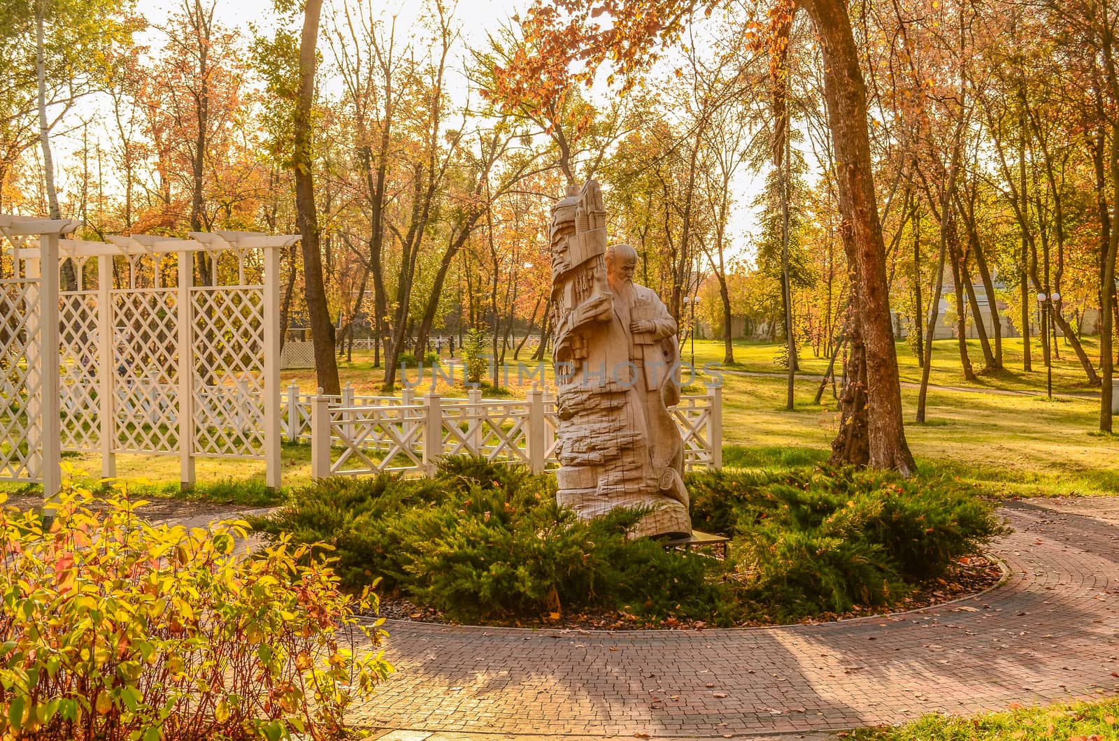 carved wooden sculpture in the autumn park by chernobrovin