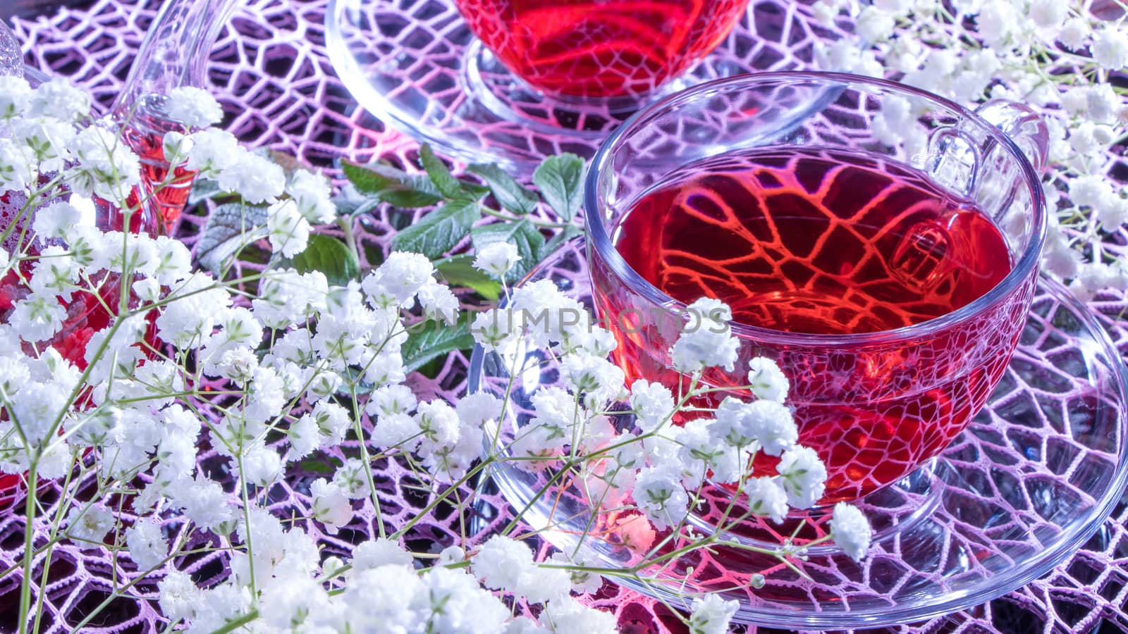 Mugs of red tea on a pink rainbow background with gypsophila flo by YevgeniySam