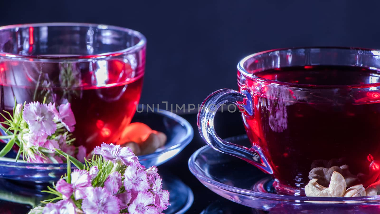 Mugs of red tea with carnation flowers. Zen tea ceremony. Horizo by YevgeniySam