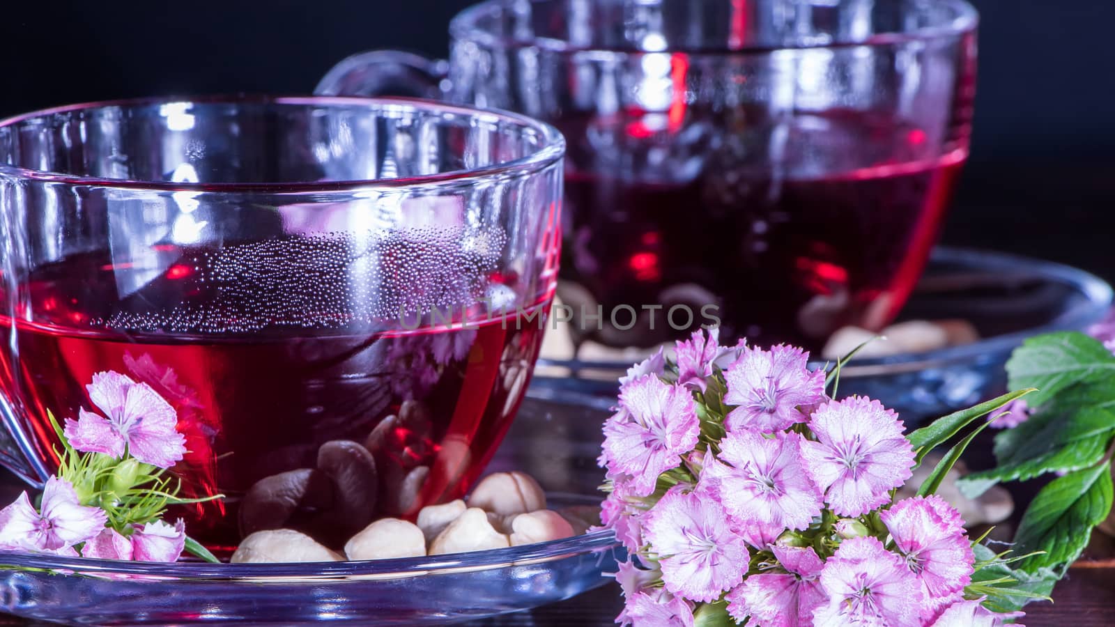 Hibiscus Red tea mug with carnation flowers close-up horizontal  by YevgeniySam