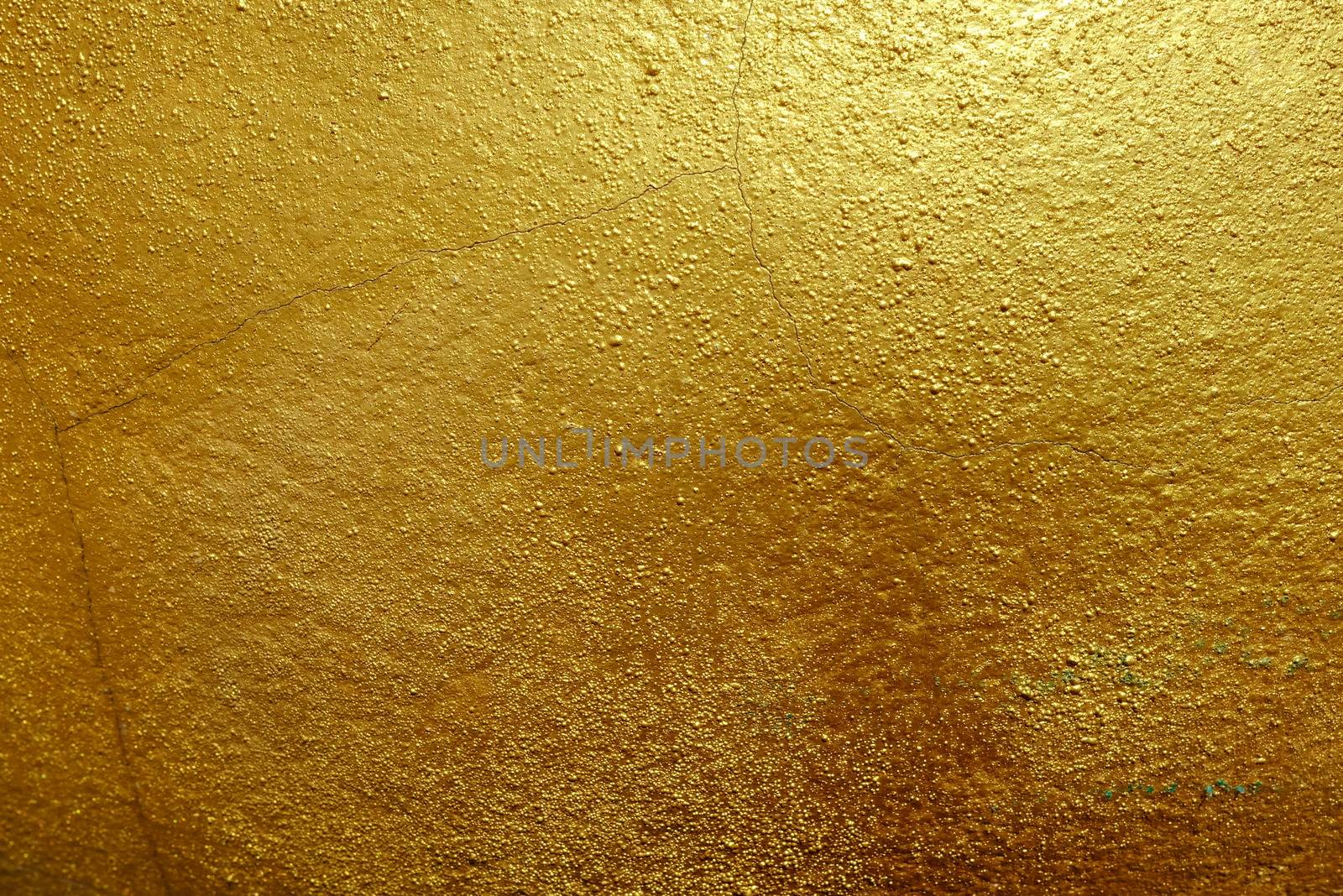 Dark Golden Paint on Stone Background.