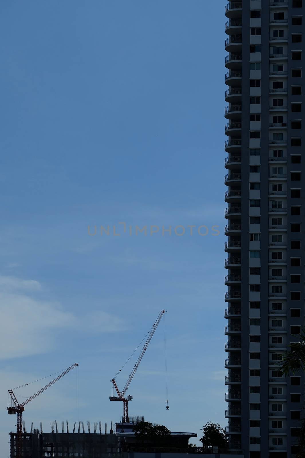 Vertical View of New Condominium Under Construction with Space for Text. by mesamong