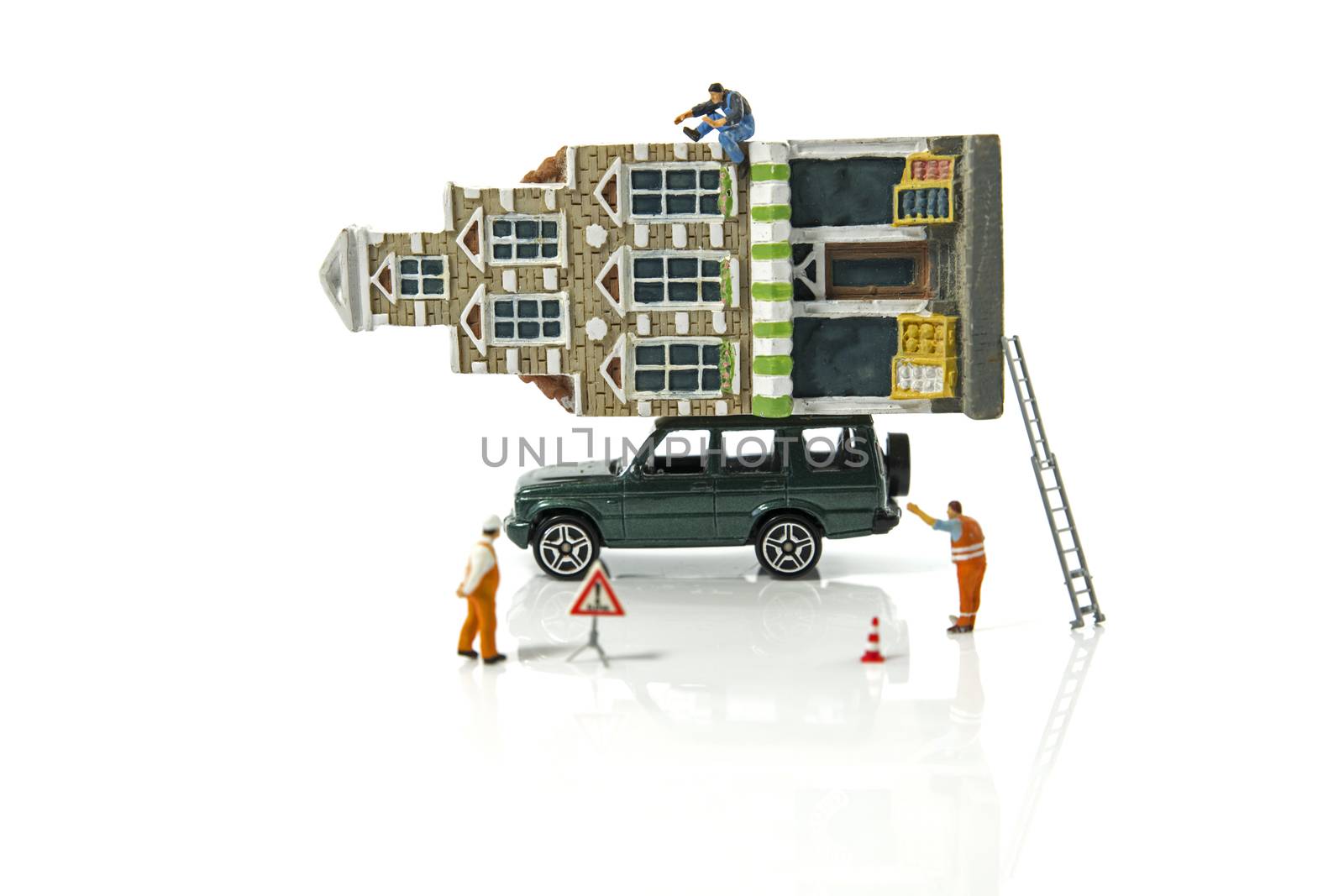 little figures moving the house on a car ready for transport