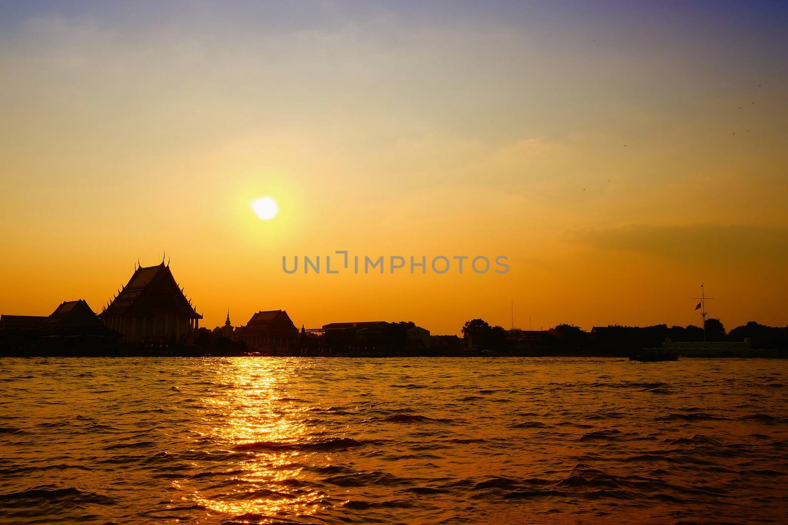 Scenery of Sunset at Chaophraya River at Pak Klong Talad Pier. Chaophraya River is the major river in Bangkok, Thailand. by mesamong