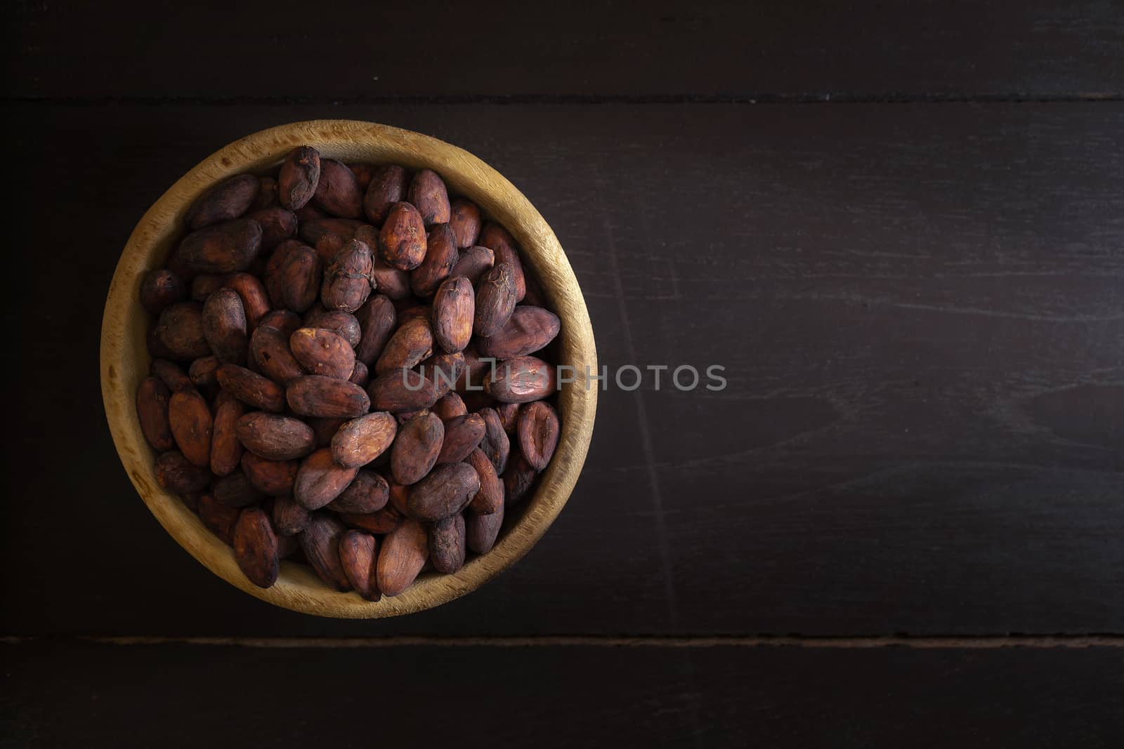 Top view of Cocoa beans in vintage table on dark background by kaiskynet