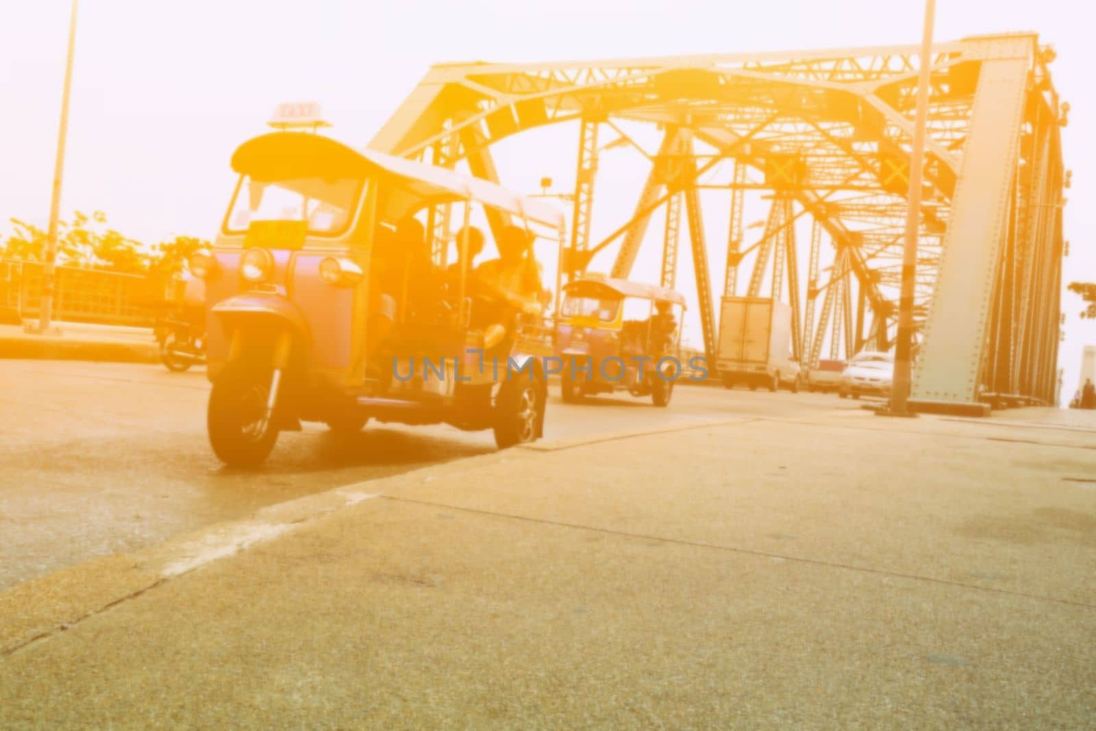 Bottom View of Blurred Thai Taxi or Tuk Tuk on Memorial Bridge Bangkok, Thailand with Light Leak. by mesamong