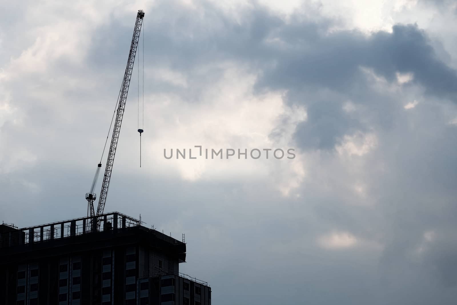 Silhouette of Under Construction Building in Cloudy Day with Space for Text.