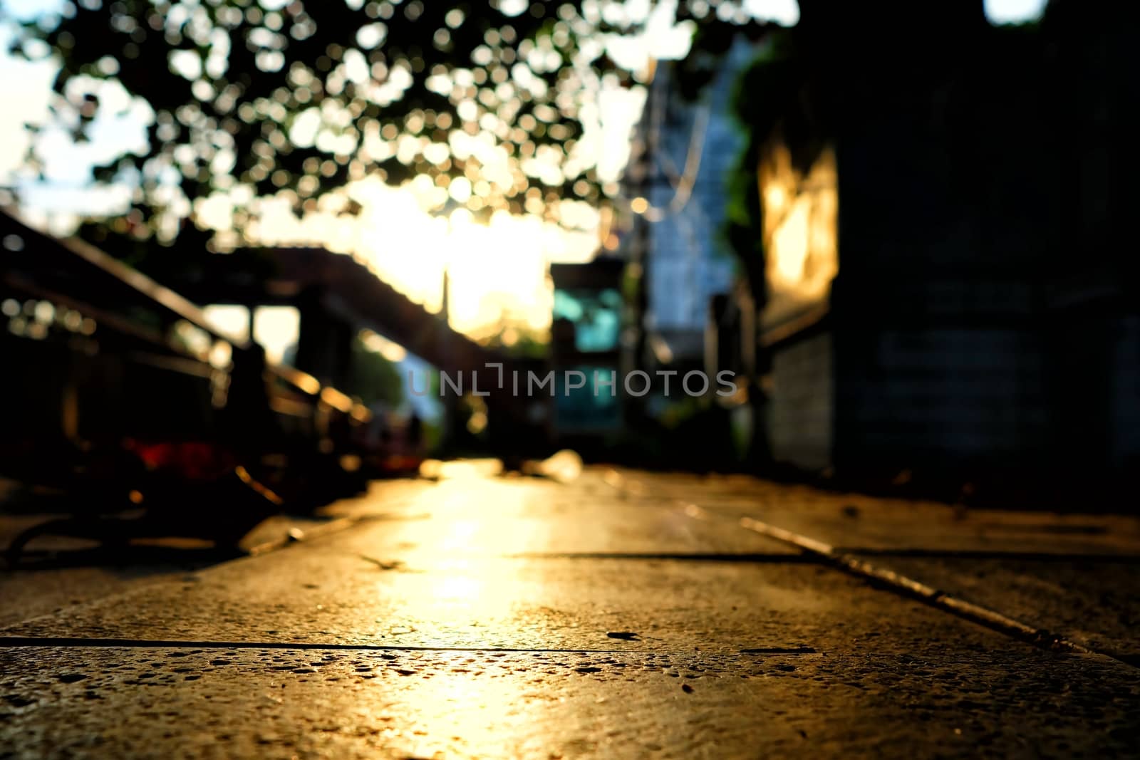 Blurred Reflection of Sunset on Footpath Background.