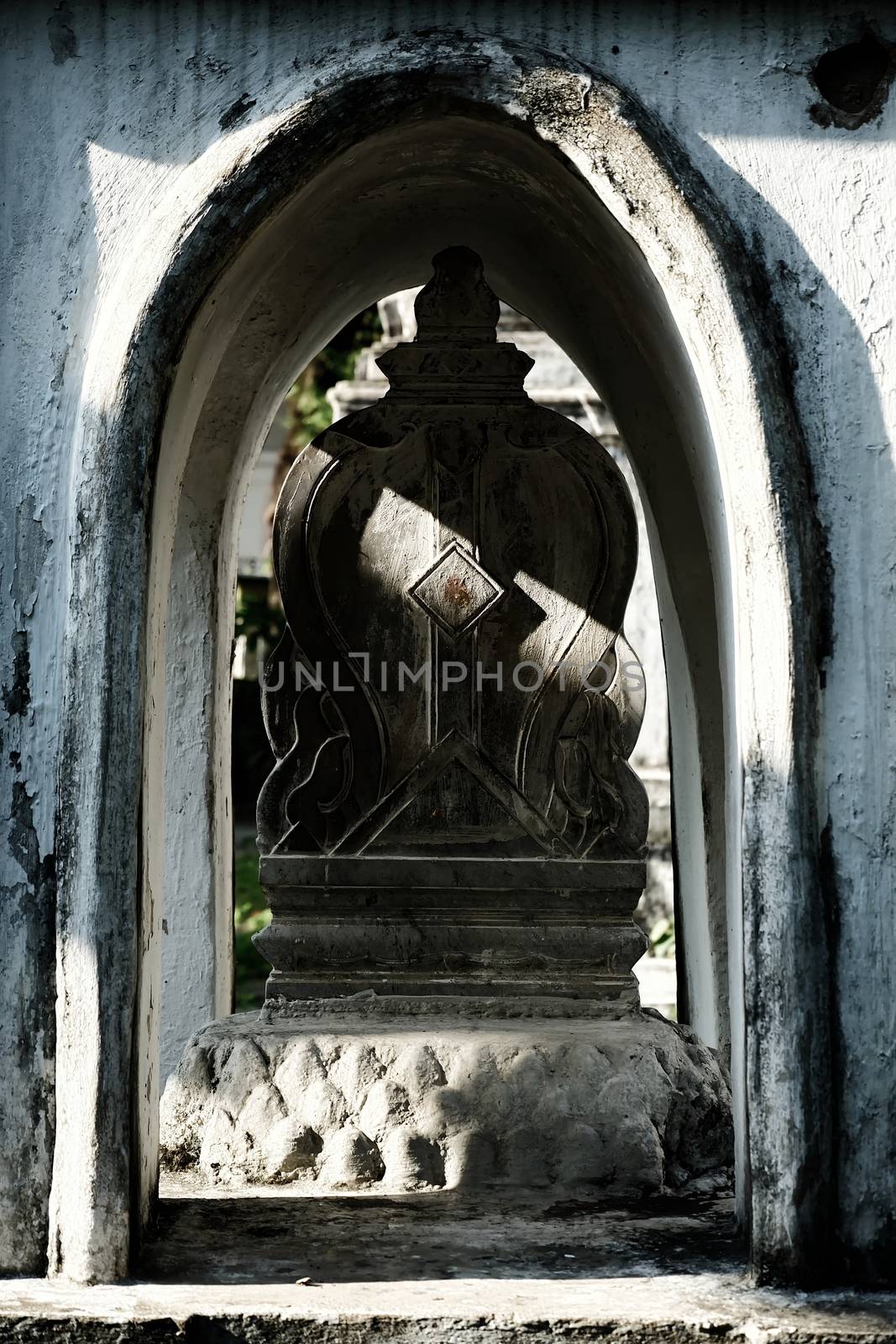 Sunlight Beam Shining on Ancient Heart-Shaped Stone Boundary Marker of Church in Thai Temple.