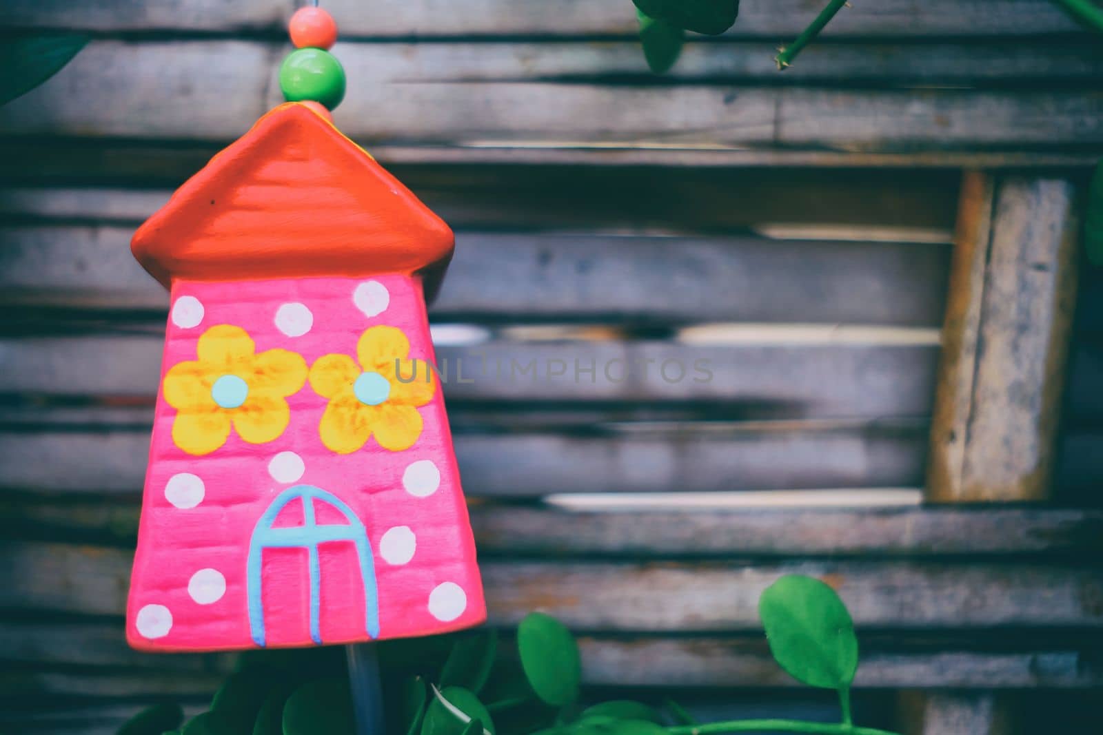 Ceramic House Hanging in The Park with Bamboo Fence Background. by mesamong