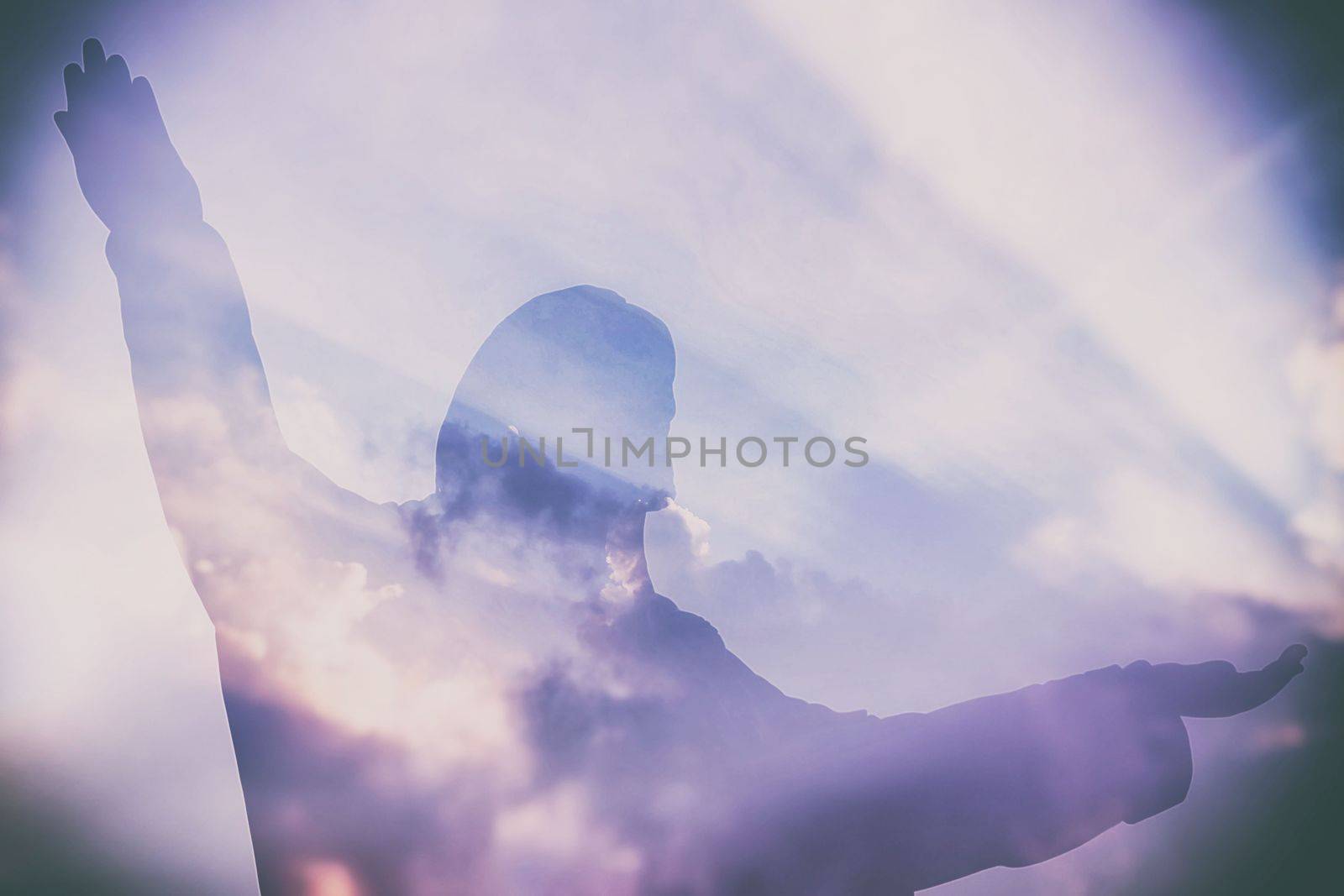 Abstract Double Exposure of Jesus Silhouette with Light Beam and Clouds.