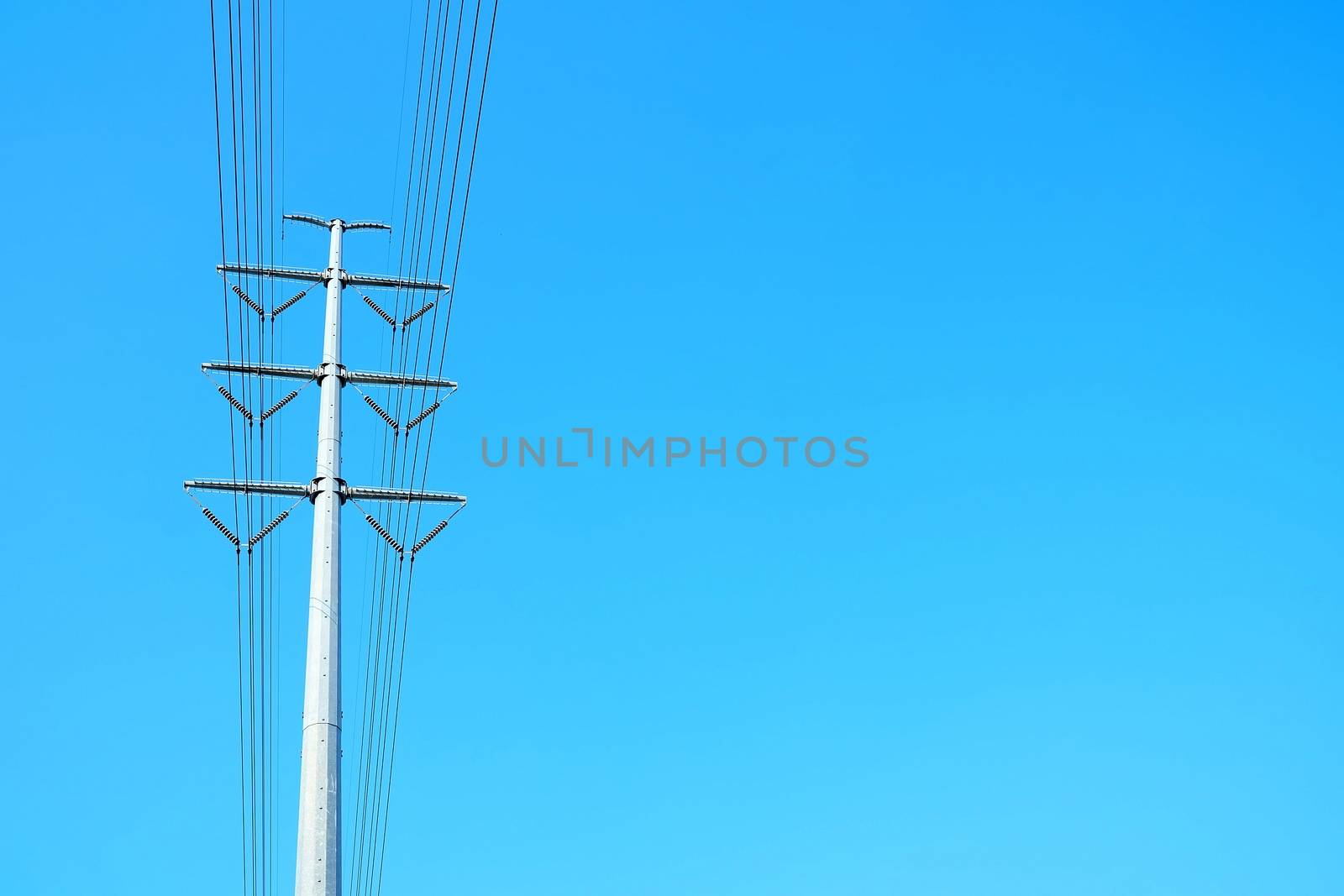 Big Electric Pole with Blue Sky with Space for Text. by mesamong