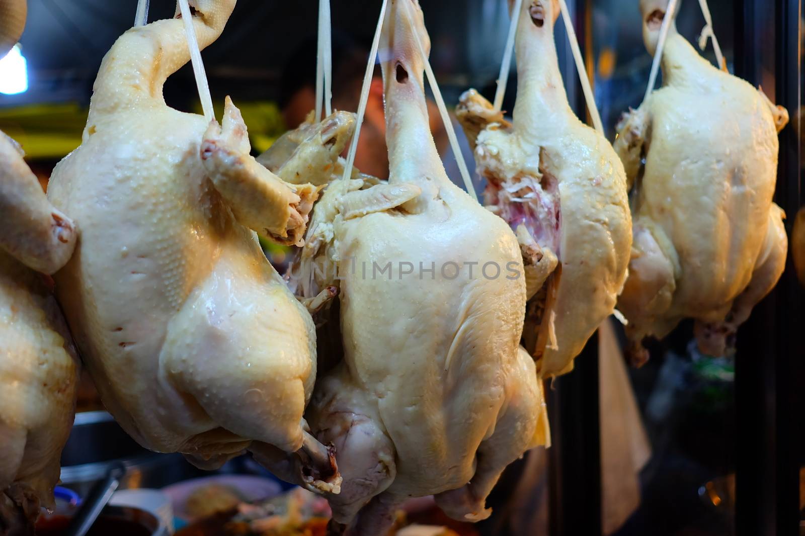 Close-up Hanging Boiled Chickens Display for Hainanese Chicken Rice Recipe.