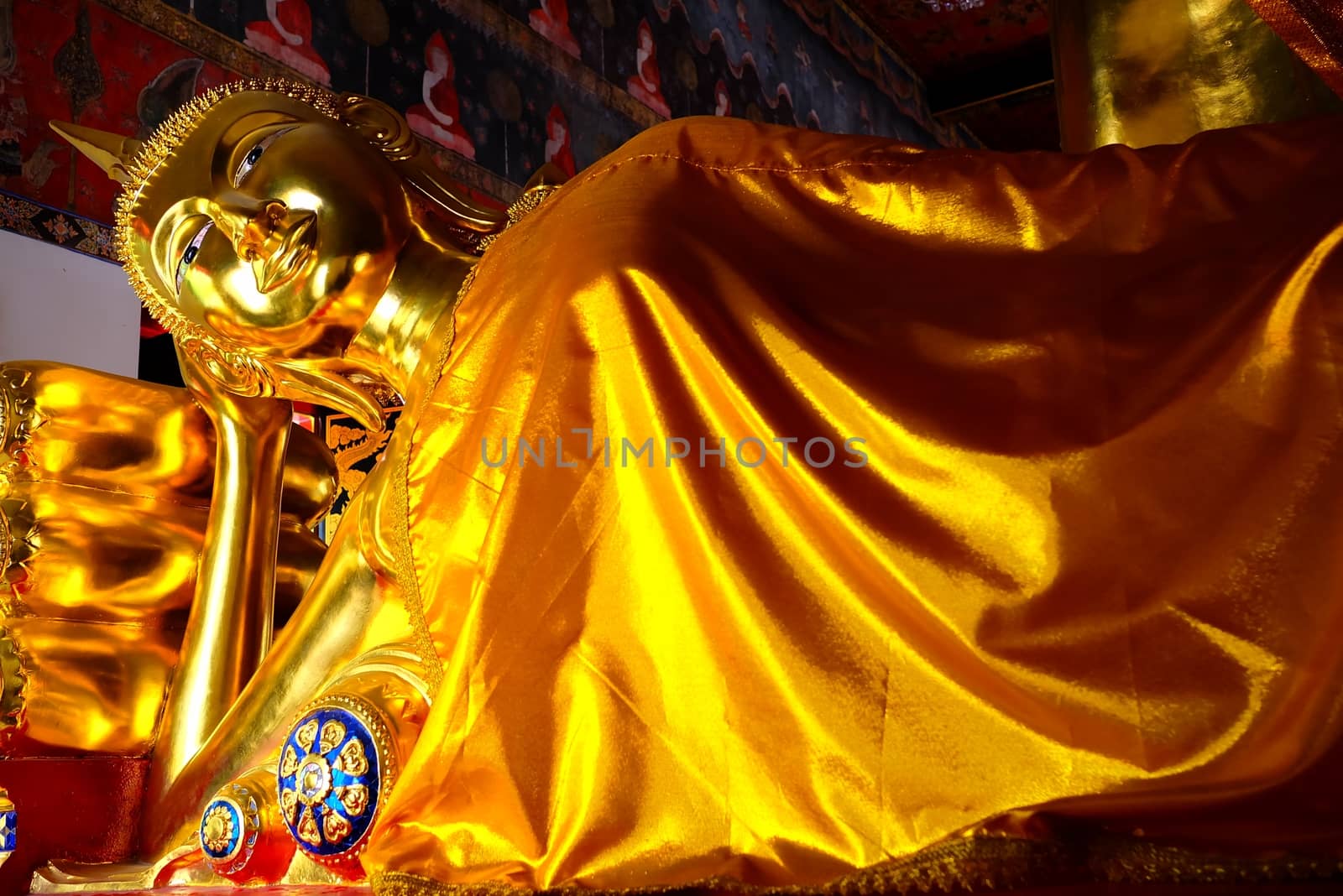 Ancient Golden Reclining Buddha at Wat Nang-Chee Choti Karam Temple, Bangkok Thailand. by mesamong