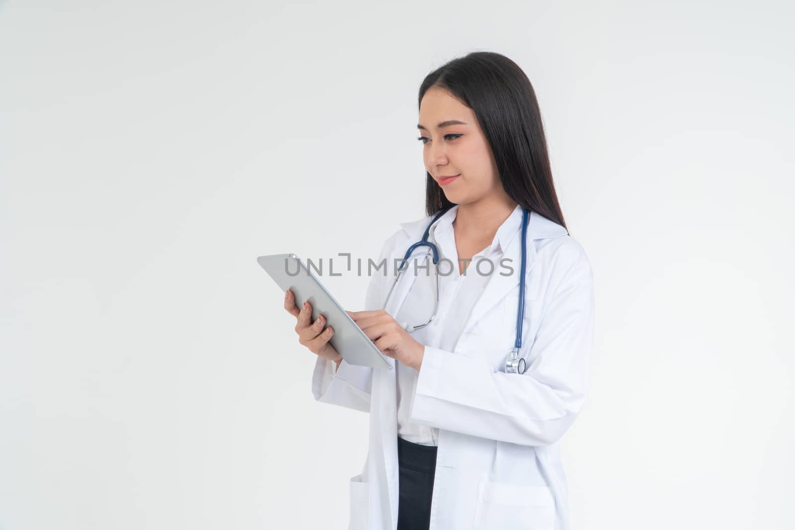 Female  Doctor or physician holding a tablet for checking patient health in hospital, Concept of online healthcare information and emergency healthcare assistance service, Medical service