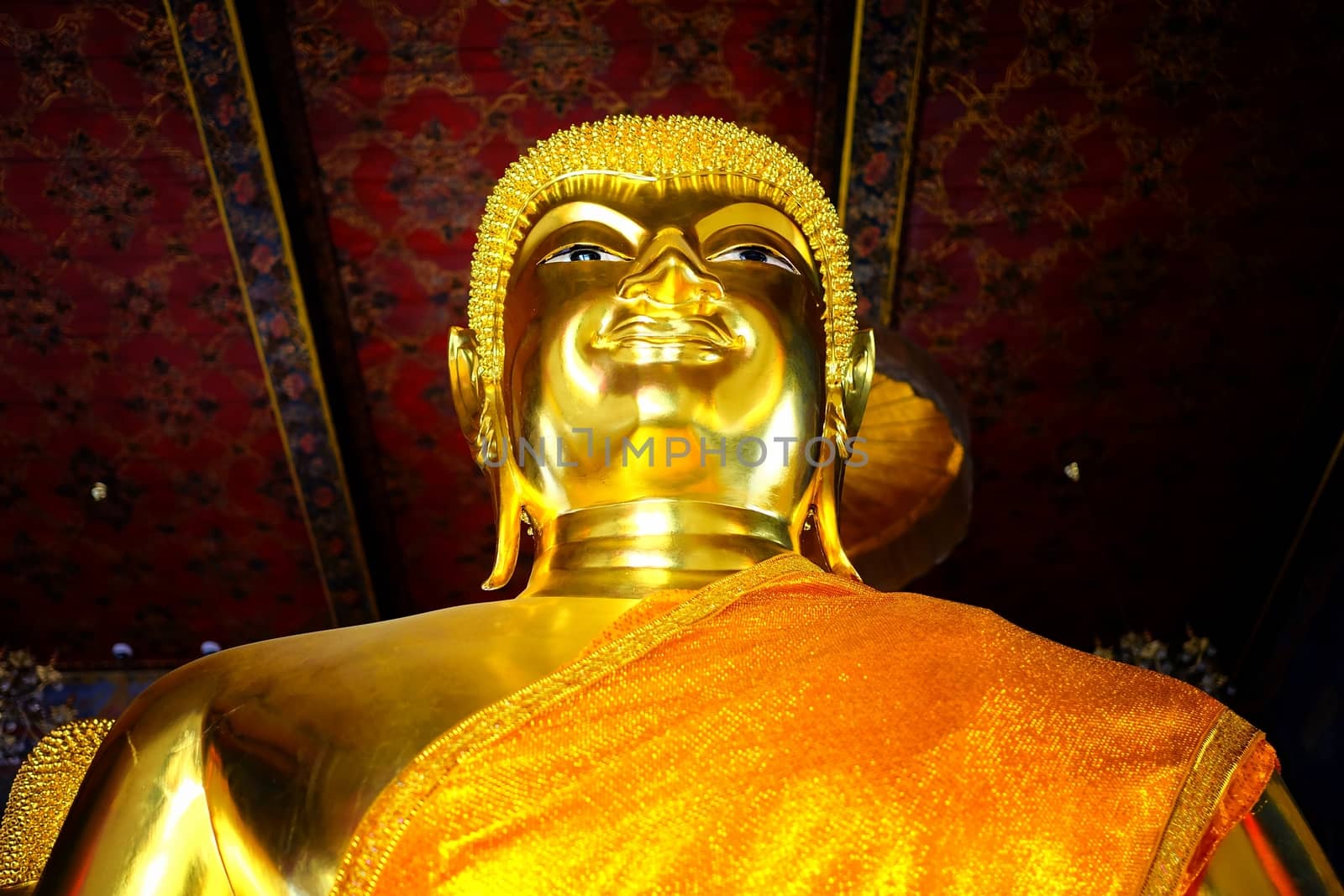 Closed-up Ancient Golden Buddha image in main hall at Wat Nang Chee Bangkok Thailand. by mesamong