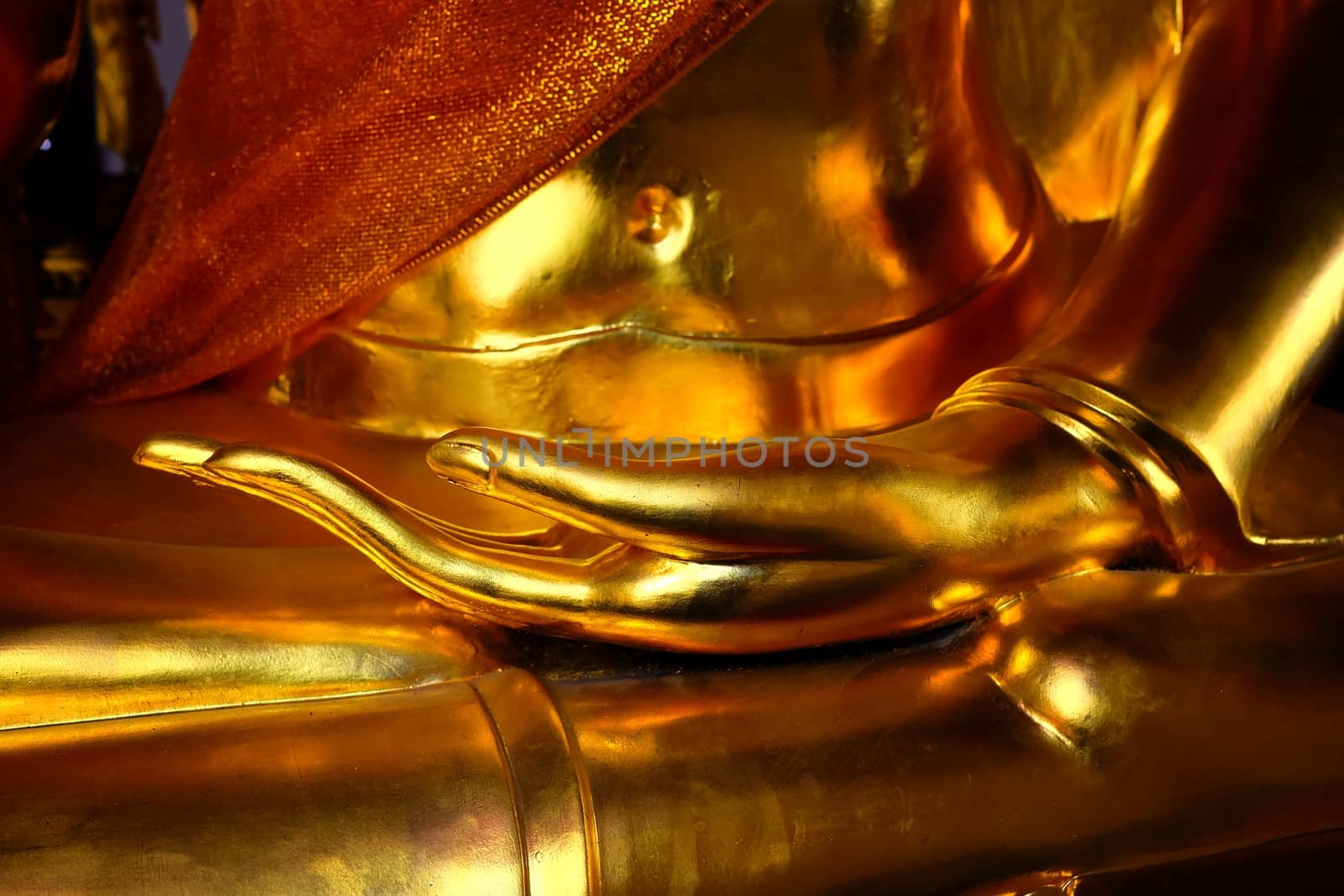 Closed-up Golden Hand of Ancient Buddha Image. by mesamong