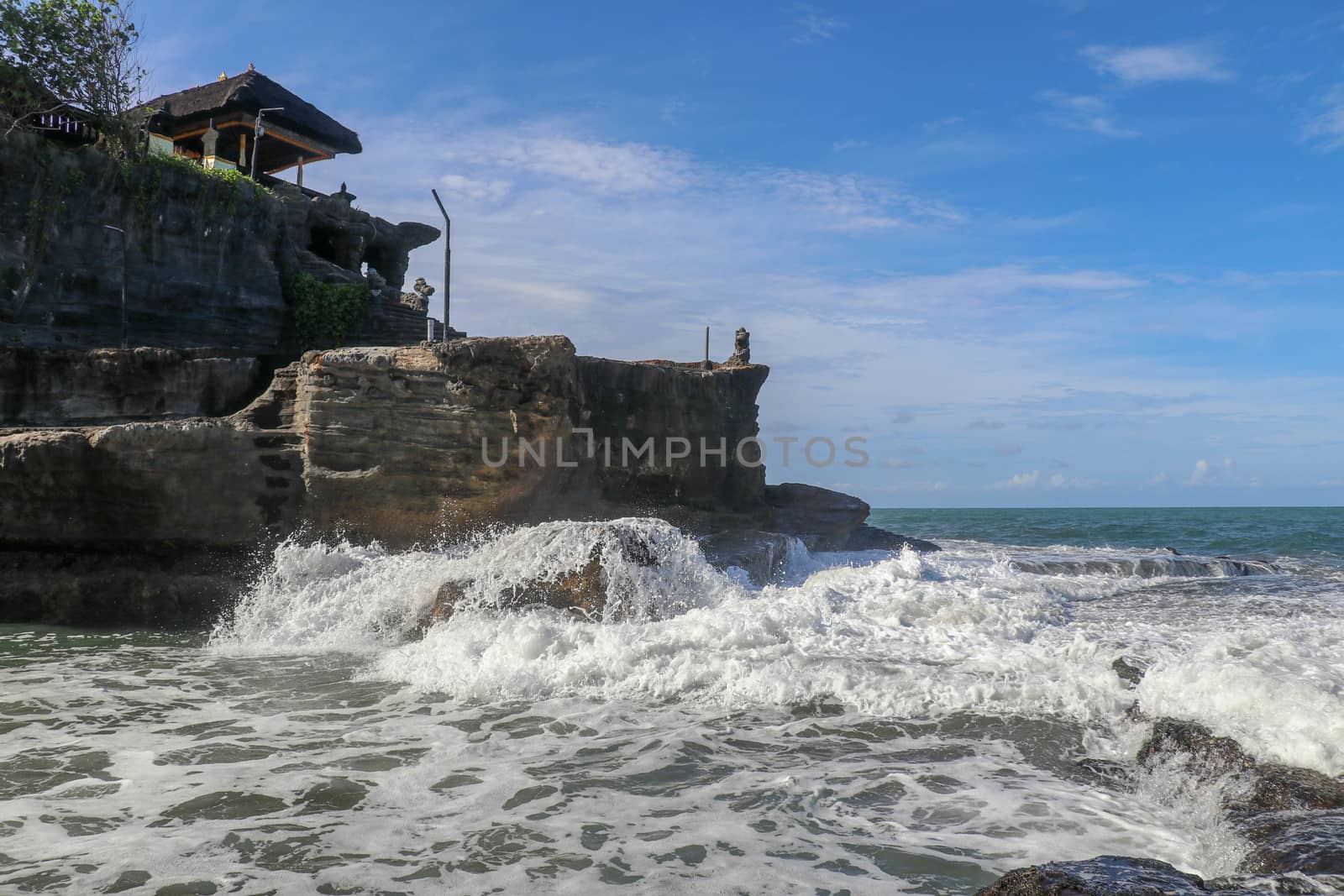 Beautiful Tanah Lot Temple in Bali Indonesia epic scene - nature and architecture background. Pilgrimage Temple of Pura Tanah Lot is perched dramatically on a large coastal rock.