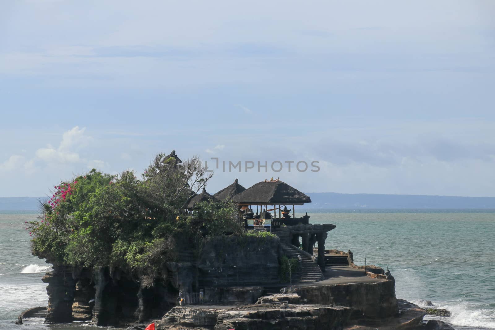 Beautiful Tanah Lot Temple in Bali Indonesia epic scene - nature and architecture background. Pilgrimage Temple of Pura Tanah Lot is perched dramatically on a large coastal rock.