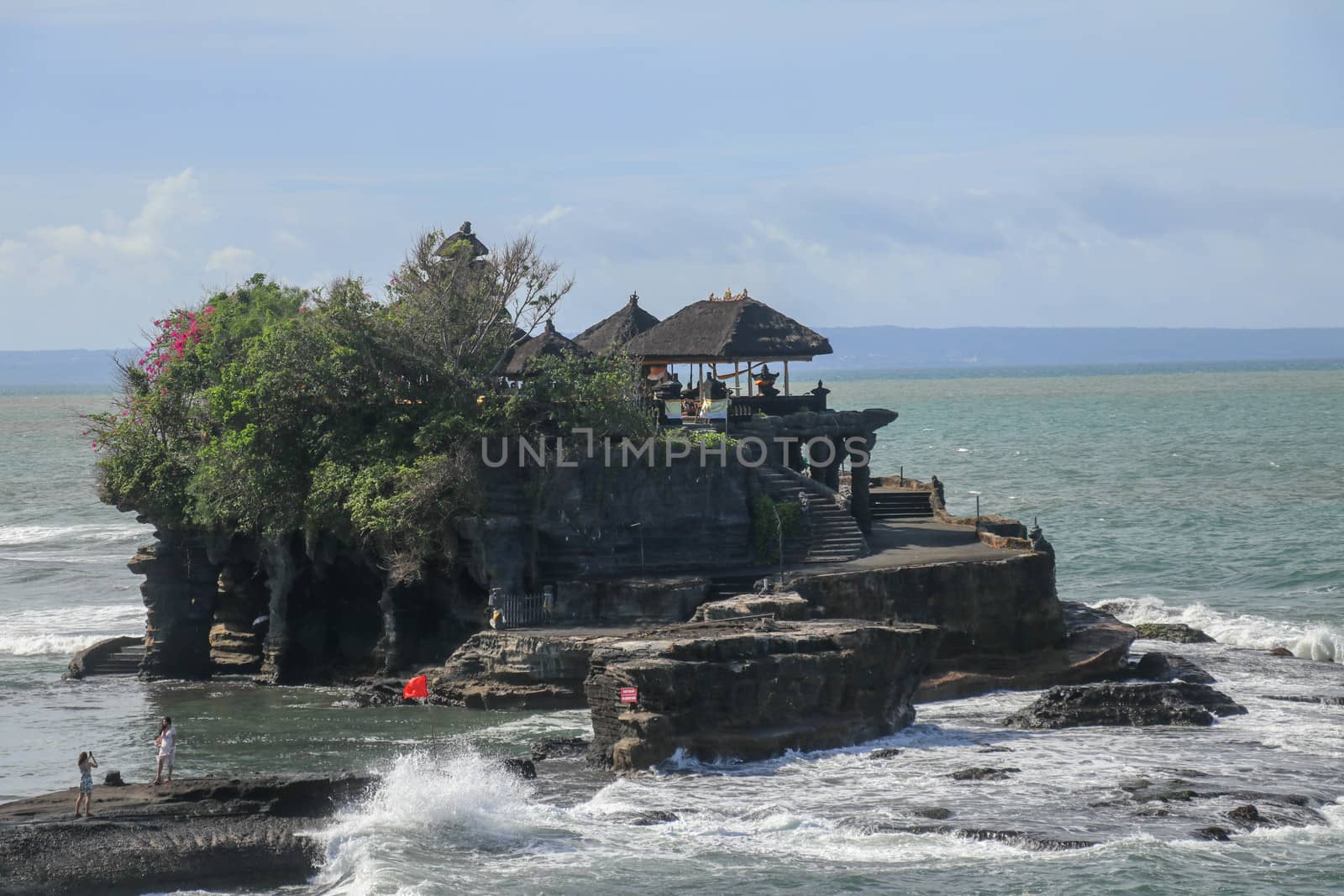 Beautiful Tanah Lot Temple in Bali Indonesia epic scene - nature and architecture background. Pilgrimage Temple of Pura Tanah Lot is perched dramatically on a large coastal rock.