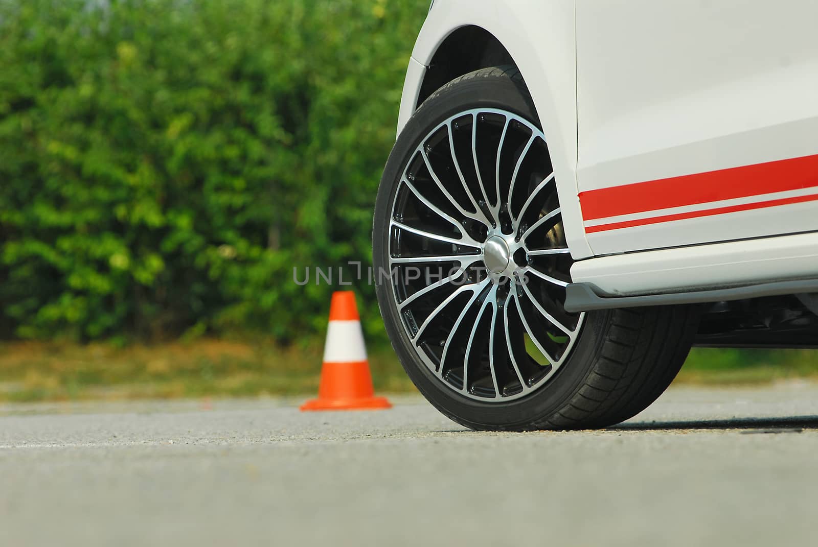 tuned small sports car and wheel with cone by aselsa