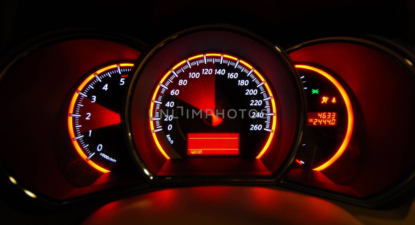 A shot of the car dashboard glowing while stationary