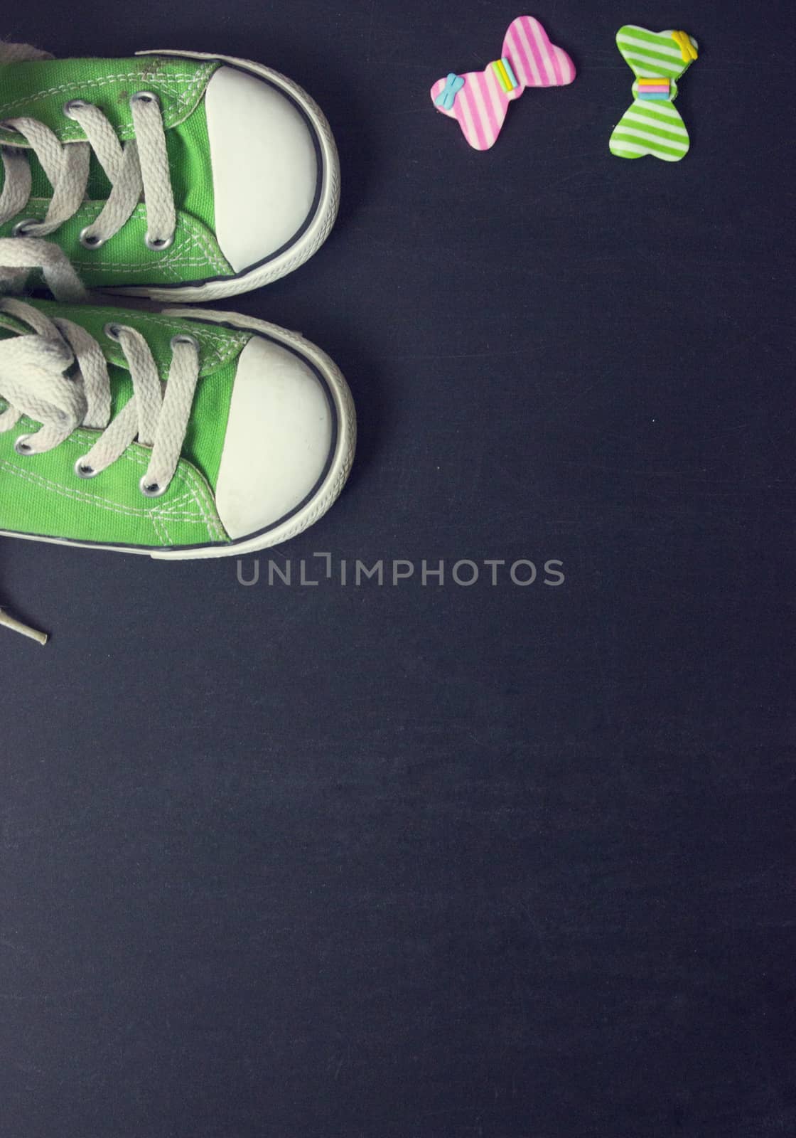 Top view of green sneakers on black board, with copy space