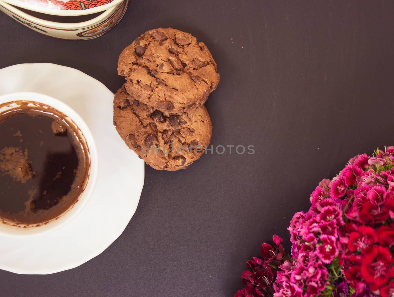 Turkish coffee with chocolate cookies on black board