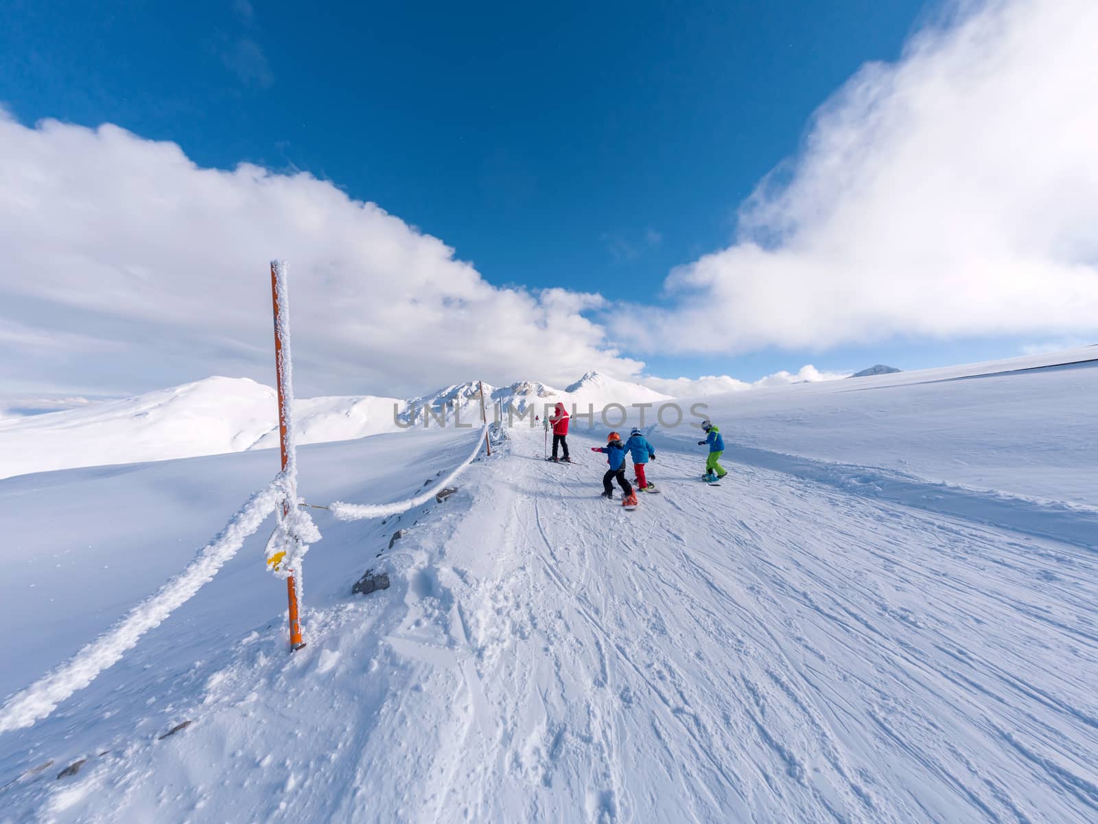 Parnassos mountain with snow and people on the slopes in a sunny day