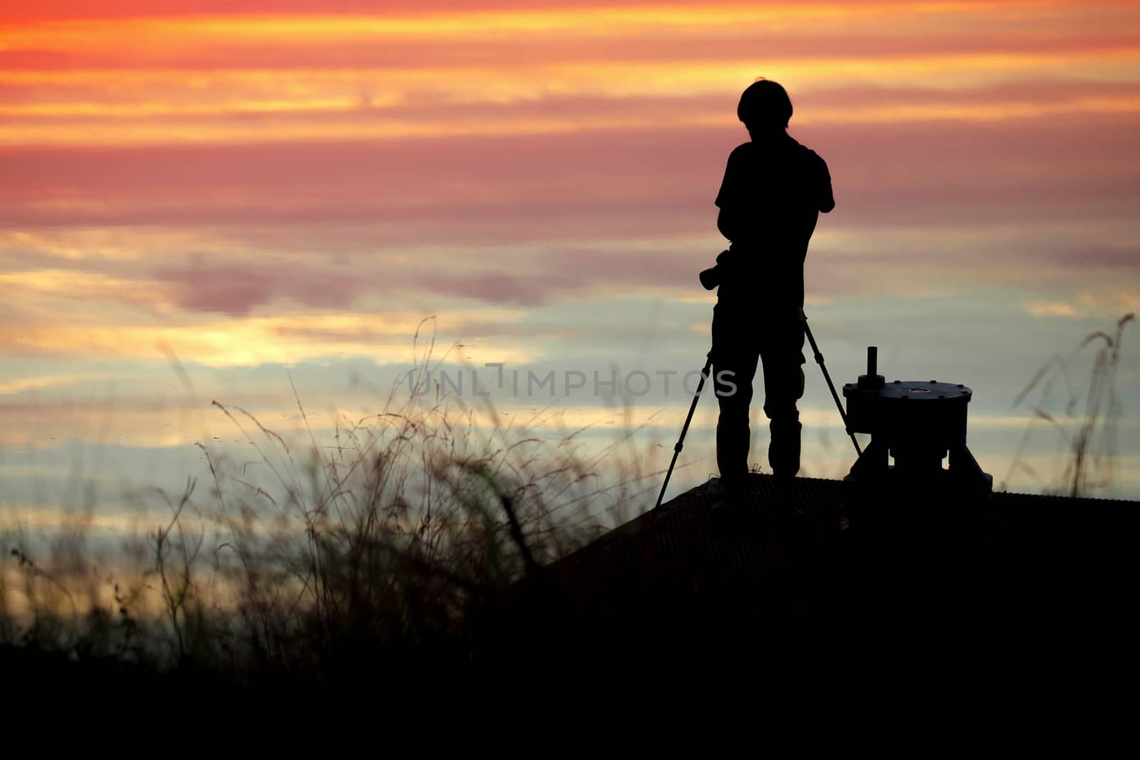 silhouette of the photographer in the Sunset with Colorful dramatic sky