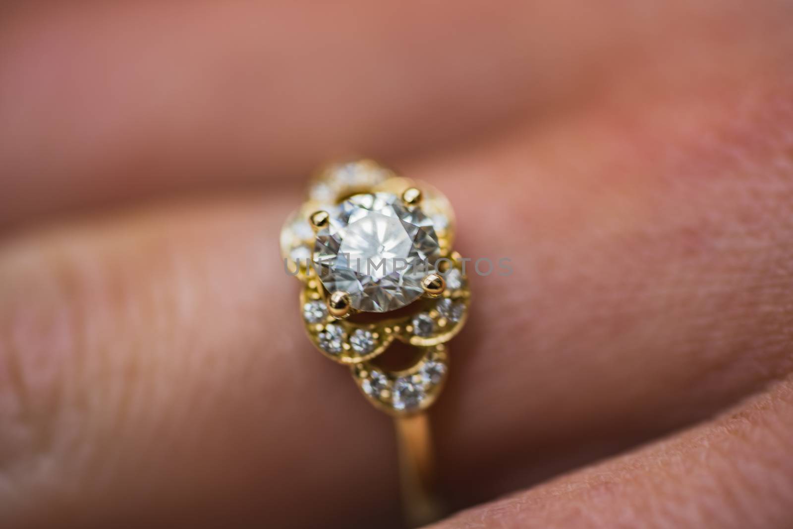 A close up of a beautiful gold diamond engagement ring